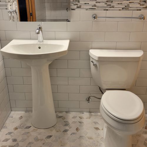 Sink and toilet in a tiled bathroom