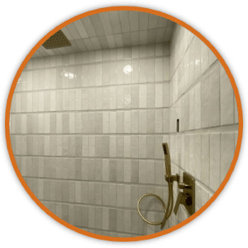 Tile walls and shower wand inside orange circle