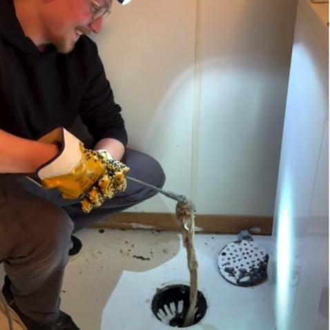 Hair being removed from floor drain