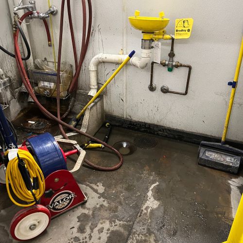 Wet basement floor with sewer line machine