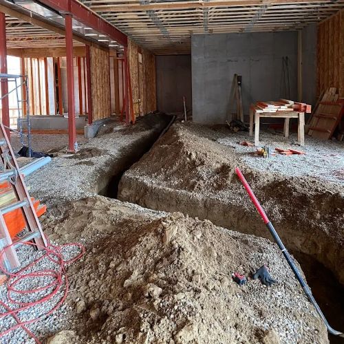 Trenches for laying pipe under a house construction