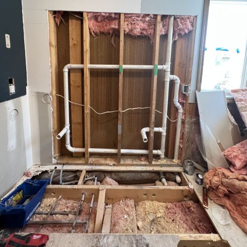 Wall and floor removed to install new pipes