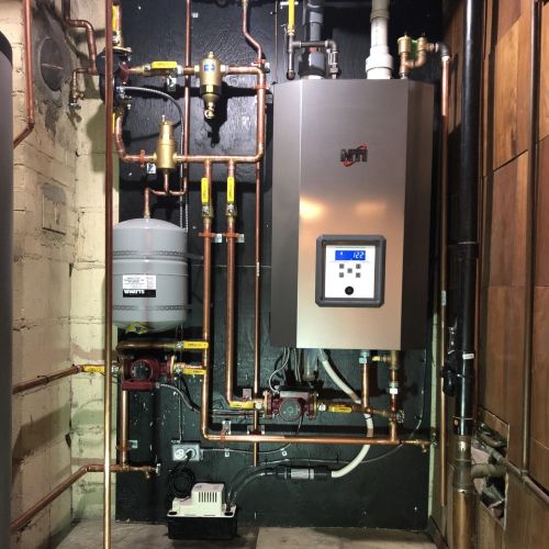 Boiler installed surrounded by pipes